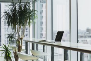 Professional office setting featuring a sleek laptop open on a tidy desk, optimized for social media management and online jobs, symbolizing modern digital work environments.