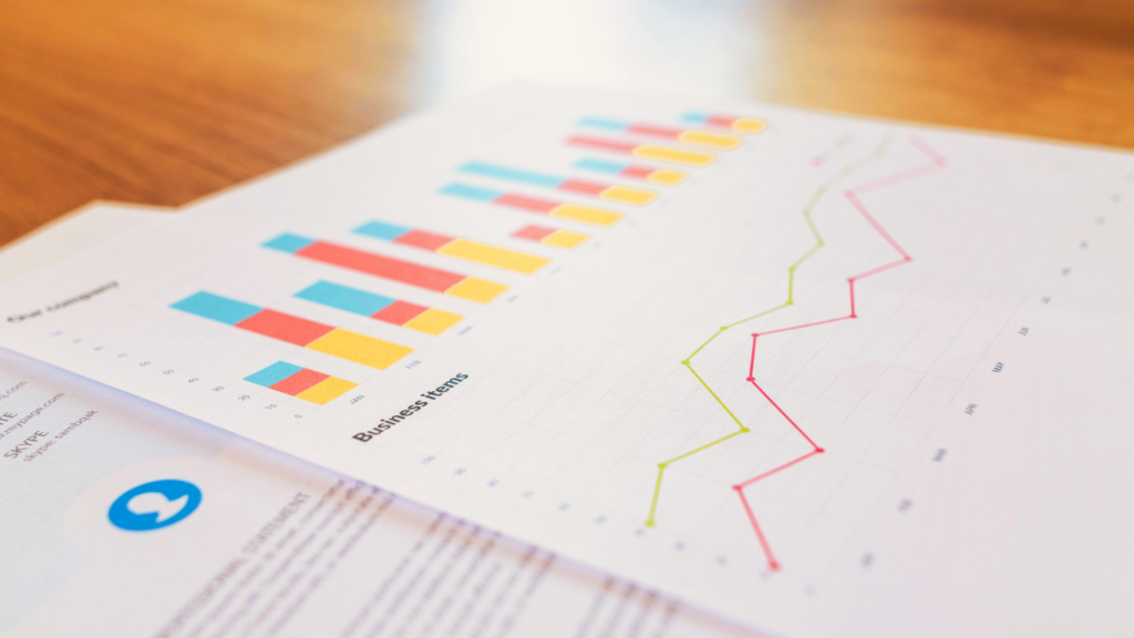 Close-up of a printed analytics report featuring colorful bar graphs and a line chart, representing the measurement and analysis of social media trends and performance metrics.