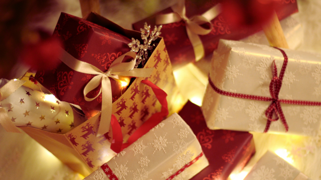 Close-up of a person's hands holding a credit card and a shopping receipt above a laptop keyboard, illustrating the convenience of using Holiday Shopping Savings Apps during the Christmas season.