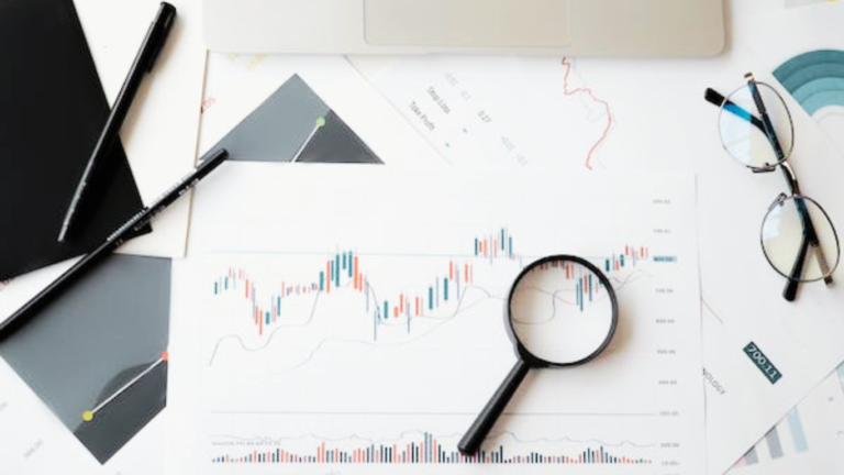 A workspace focused on analysis for improving website SEO, with a magnifying glass highlighting important data on a printed graph. The scene includes a laptop, eyeglasses, a pen, and another set of charts, suggesting a strategic approach to enhancing search engine optimization. The magnifying glass and the data under scrutiny emphasize the essay's main keyword: 'How to Improve Website SEO'.